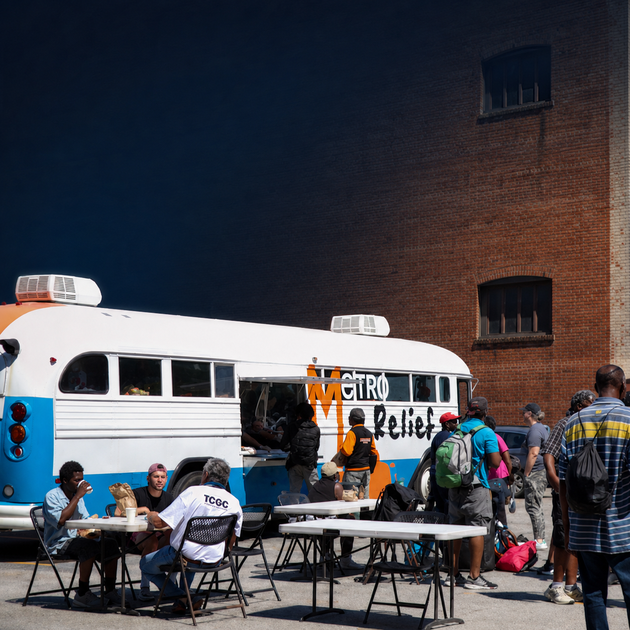Metro Relief volunteers serving alongside the outreach bus